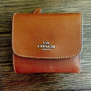 Brown coach trifold wallet with rainbow credit card slots